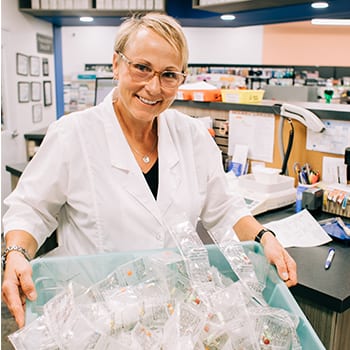 Lady holding the basket full of medicines