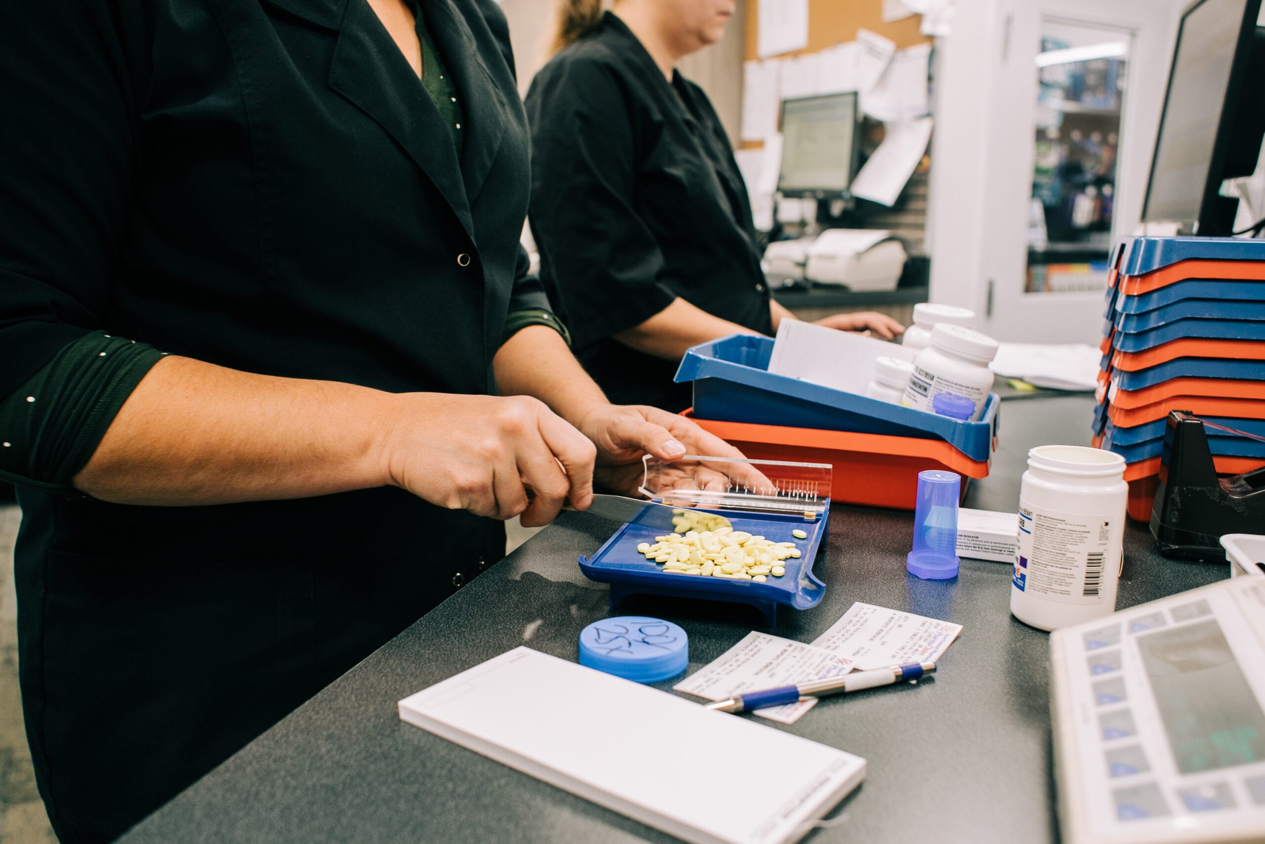 Woman counting medicines and packing